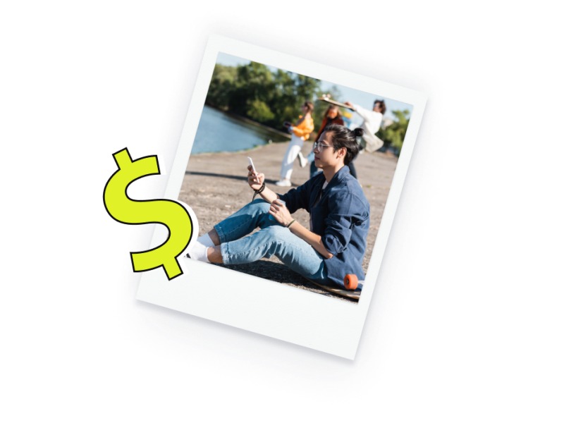 polaroid-style photo of a person sitting outside near a lake, using their cell phone