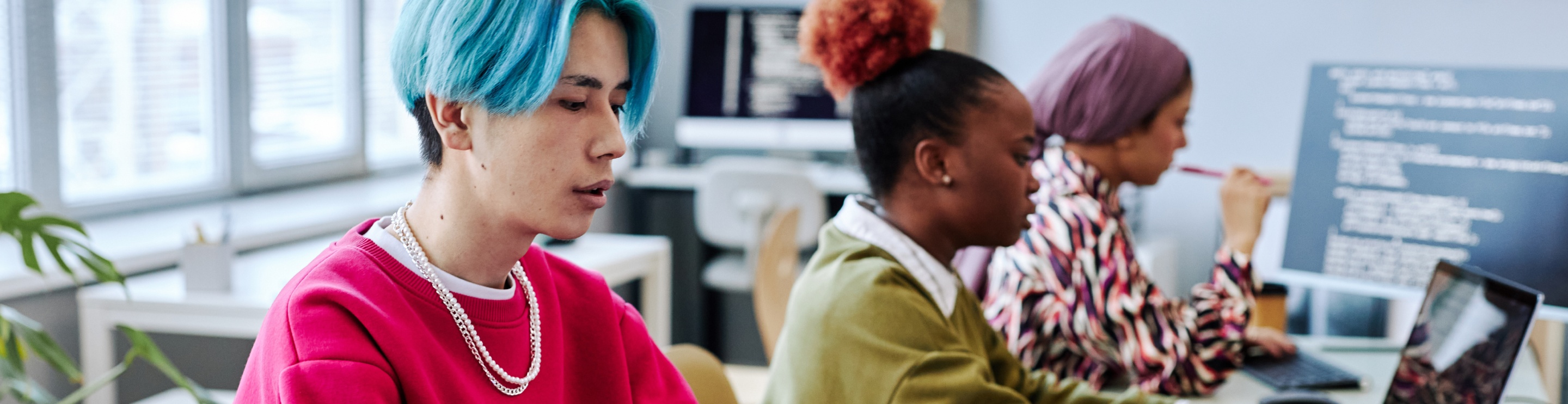 people use computers and laptops in a public space