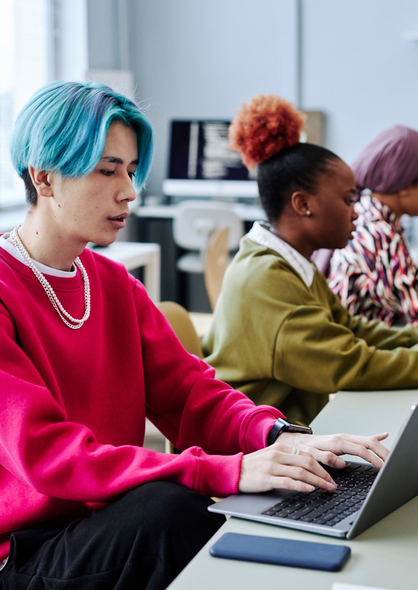 people use computers and laptops in a public space