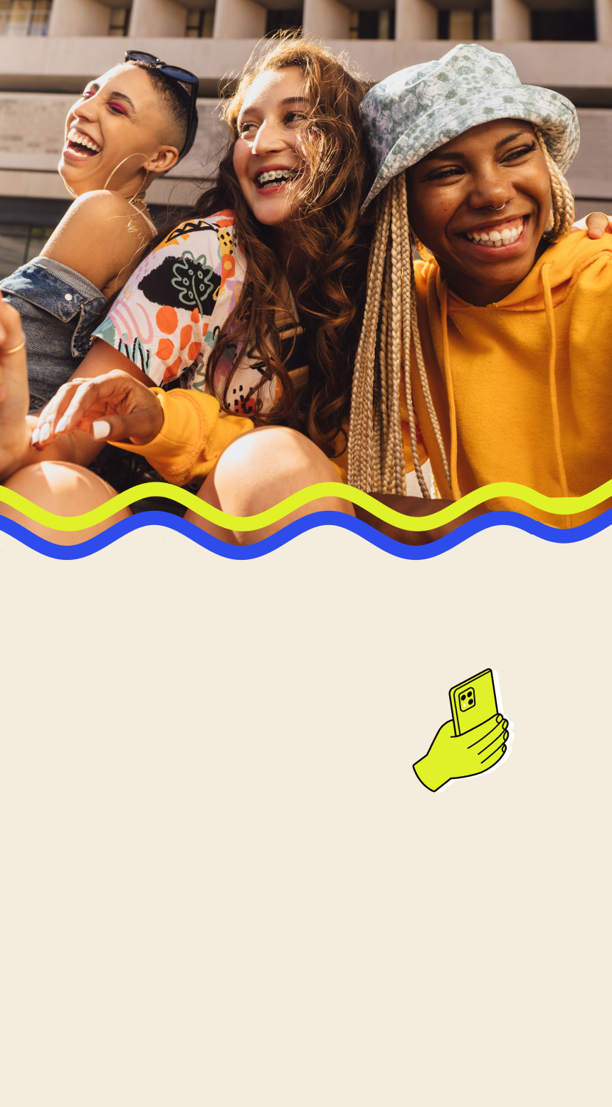 three young women laughing together