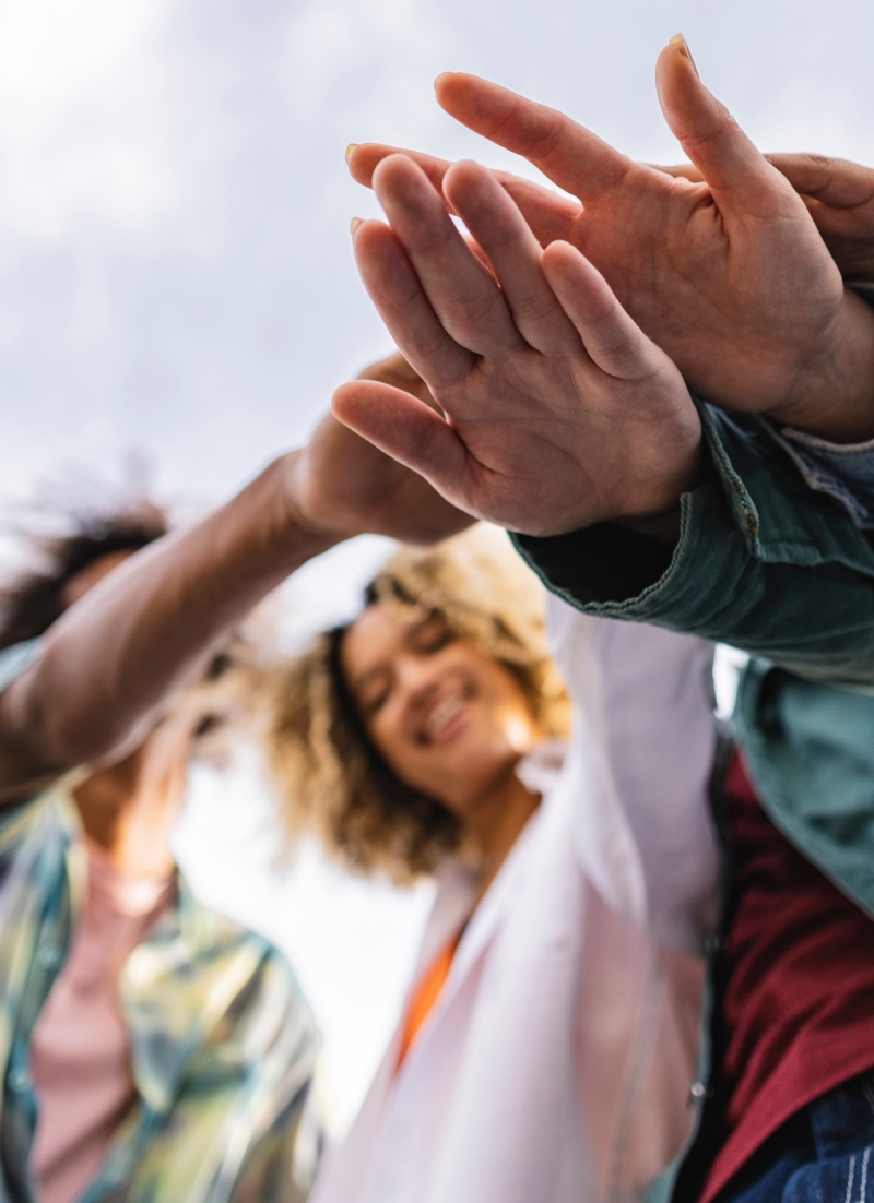 people put their hands in a huddle