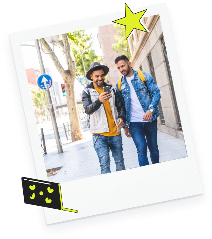 a polaroid-style photo of two men walking down the street looking at a phone, icons of a star and wallet with hearts