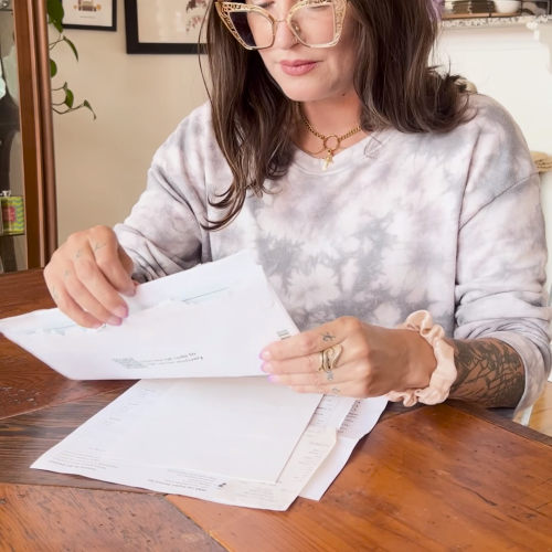 a still image of a person reading a bill. Text: Worried about credit card debt? There's a way out.
