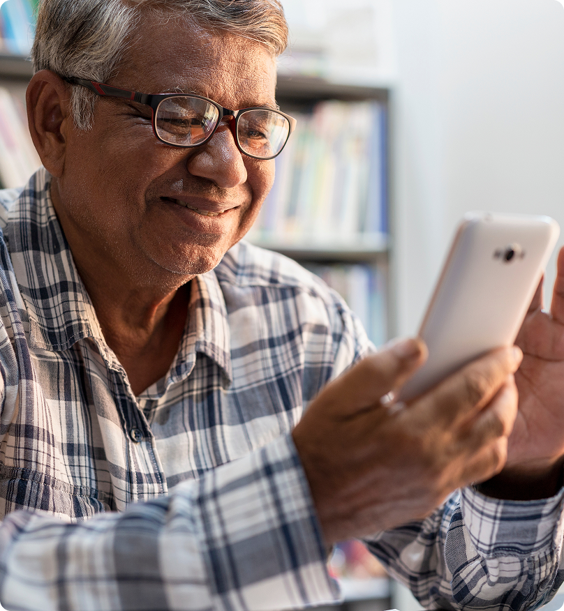 man wearing a flannel shirt, using a phone