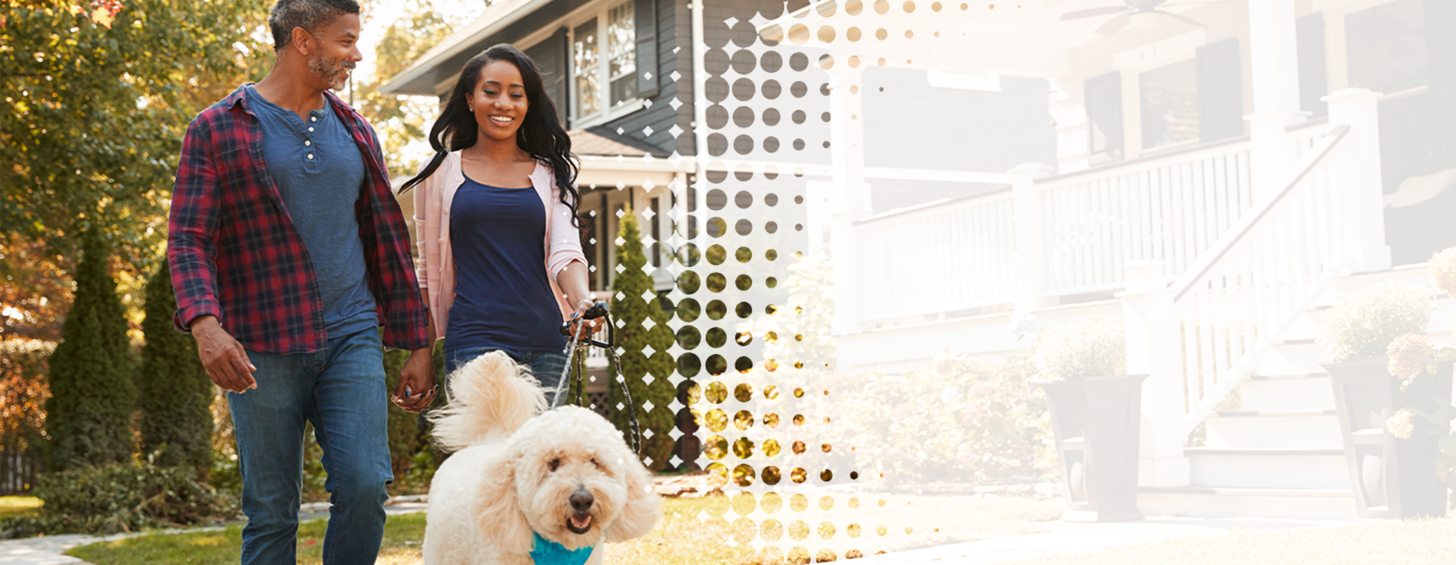 a couple walking their dog outside in a neighborhood