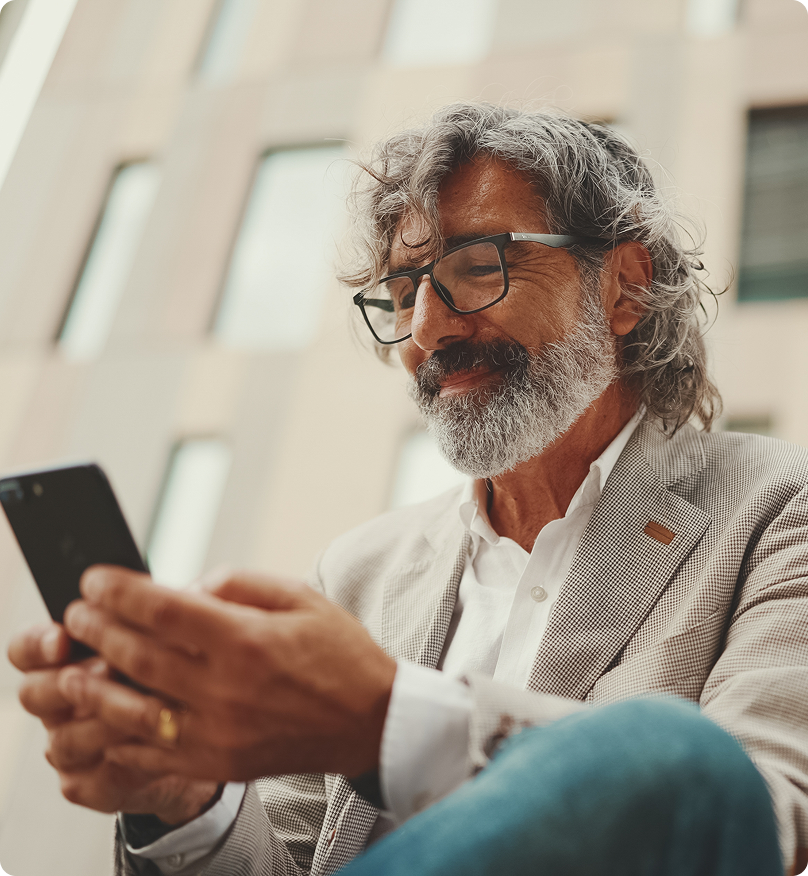 man wearing a suit, using a phone