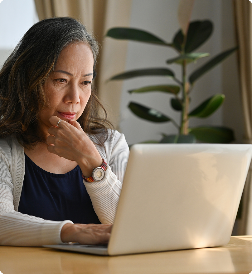 woman sitting at a table using a laptop