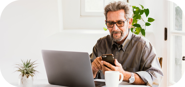 Man with Phone and Laptop